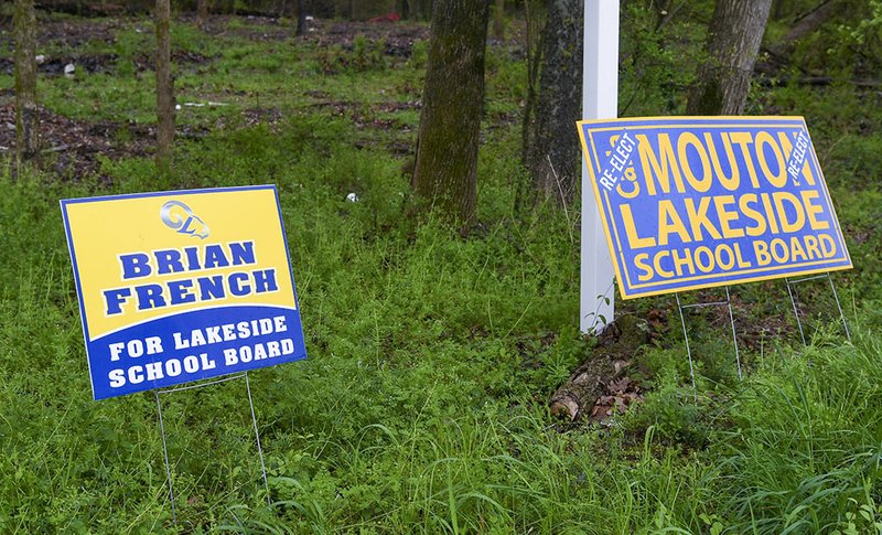 The Sentinel-Record/Grace Brown RUNOFF: Campaign signs for the candidates in today's runoff election for the Lakeside School Board are displayed Monday in the 2800 block of Malvern Avenue.