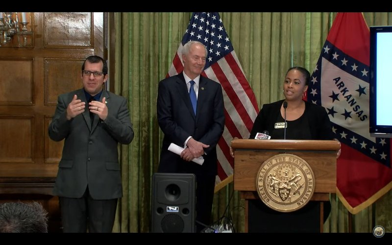 Keesa Smith, center, Arkansas Department of Human Service deputy director for youth, children and families, joined Gov. Asa Hutchinson, left, Tuesday at his daily press briefing, which was held at the State Capitol.