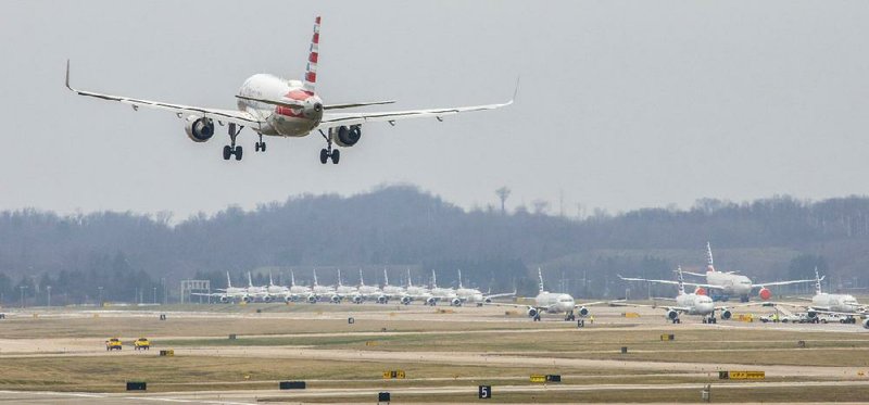 An American Airlines plane heads in for a landing near dozens of parked jets on Friday at Pittsburgh International Airport in Moon Township, Pa. The airport has become a parking area for the airline during the pandemic.
(Andrew Rush/Pittsburgh Post-Gazette)