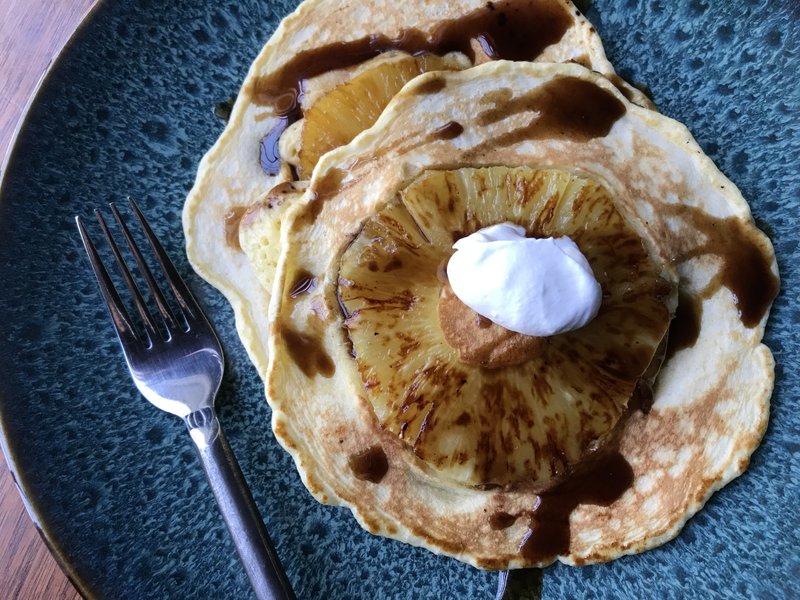 Caramelized Pineapple Pancakes with Rum Syrup and whipped cream (Arkansas Democrat-Gazette/Kelly Brant)