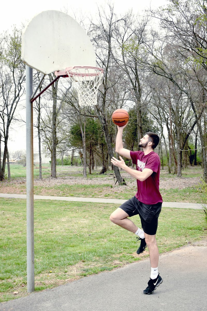 MARK HUMPHREY ENTERPRISE-LEADER Former Lincoln star, Shandon "Biggie" Goldman, shoots baskets at Lincoln's city park Friday. Goldman will earn a degree from Northern Iowa in May, then transfer to Tennessee Tech for his remaining season of collegiate eligibility. He opted to redshirt this past season saving one season of eligibility. The 6-foot-10 forward, a proficient 3-point shooter, dreams of playing professional basketball. He toured Italy last summer with Northern Iowa and will consider playing professionally in Europe once his college career is over.