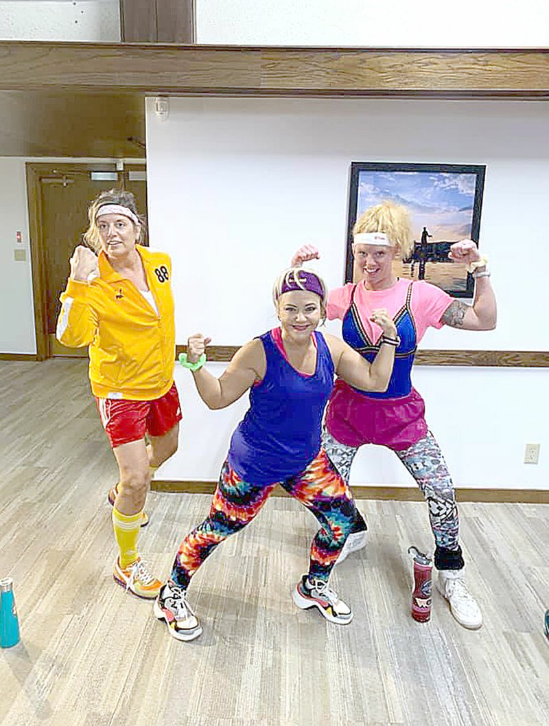 Photo submitted Joan Glubczynski, Lucy Quarti, and Jessica Anson, all part of the POA Recreation Department, dressed up for a special themed fitness class that was live-streamed last week from the Country Club board room.