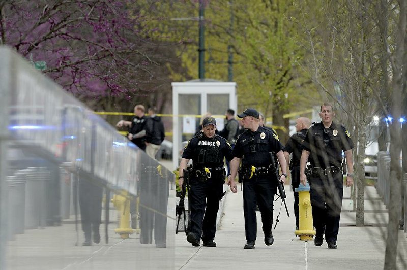 Law enforcement officers surround Buncombe County Court- house and City Hall in downtown Asheville, N.C., after shots were red Tuesday. (Angela Wilhelm/The Asheville Citizen-Times via AP) 
