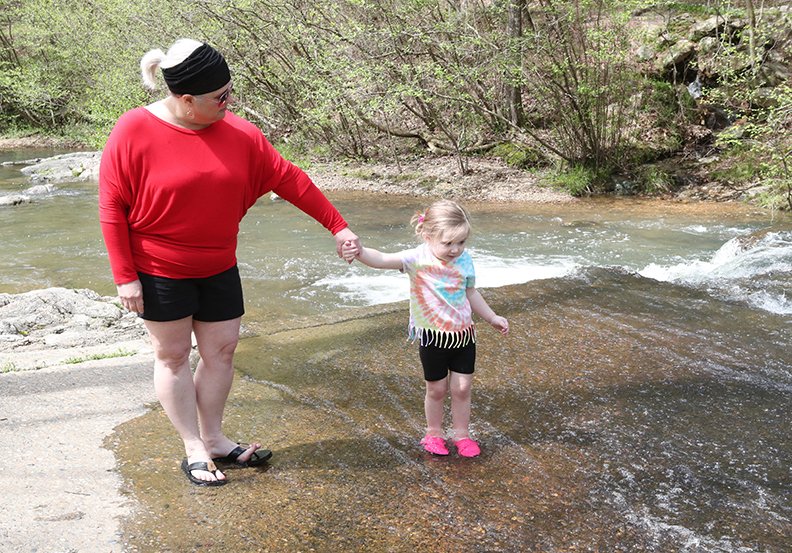 Amanda Carpenter, left, and granddaughter Bianca Pennington, 2, spend some time in the water at Gulpha Gorge Campground and picnic area Wednesday. - Photo by Richard Rasmussen of The Sentinel-Record