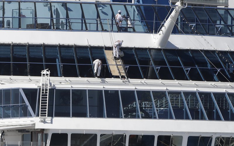 Crew members work on Oceania Cruises' Sirena cruise ship docked at PortMiami, Tuesday, March 31, 2020, in Miami. (AP Photo/Wilfredo Lee)