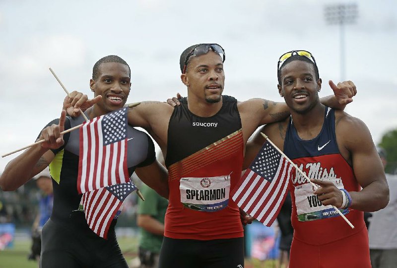 Former Arkansas sprinter Wallace Spearmon Jr. (center) of Fayetteville celebrates in 2012 with Maurice Mitchell (left) and Isiah Young after making the U.S. Olympic track and fi eld team in the 200 meters. Spearmon was taking aim at his third Olympics appearance before the Tokyo Games were postponed until 2021 by the coronavirus pandemic.
(AP fi le photo)