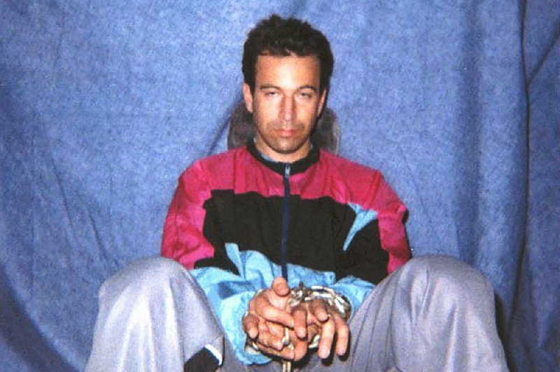 FILE - This file photo obtained on Jan. 30, 2002, shows Wall Street Journal reporter Daniel Pearl in captivity by Pakistani militants. A videotape received by U.S. diplomats in February 2002 confirmed that Pearl had been killed. On Thursday, April 2, 2020, a Pakistani court overturned the murder conviction of British-born Pakistani Ahmed Omar Saeed Sheikh, who was found guilty of Pearl's kidnapping and killing and has spent 18 years in prison. (AP Photo)