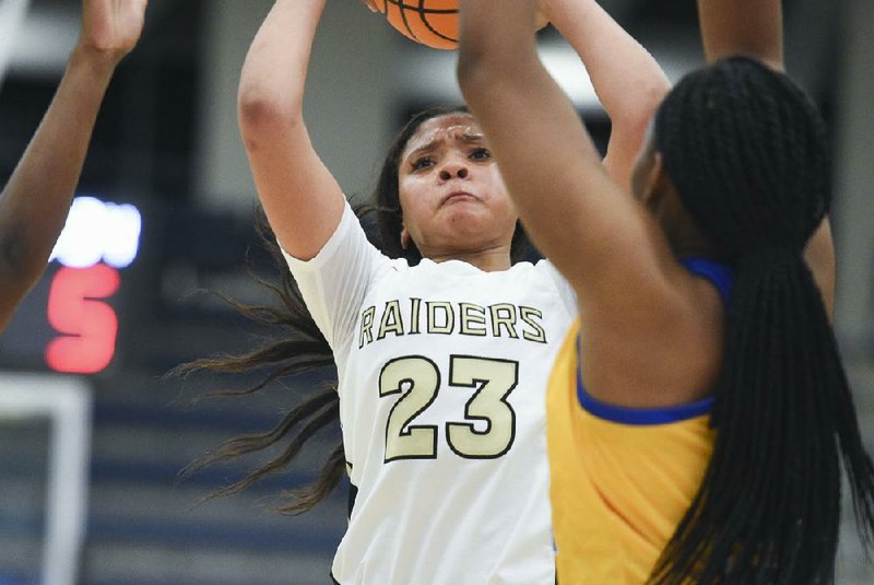 Nettleton’s Elauna Eaton shoots during the Great 8 girls basketball tournament Dec. 7 at Rogers Heritage in Rogers. The shot clock in the background, which has been used in some tournaments the past two years, will be used in Class 6A games starting next season.
(NWA Democrat-Gazette/Charlie Kaijo)

