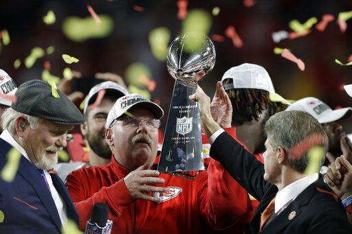 Kansas City Chiefs chairman Clark Hunt, right, hands the trophy to head coach Andy Reid Feb. 2 after the chiefs defeated the San Francisco 49ers in the NFL Super Bowl 54 in Miami Gardens, Fla. It's hard enough when things are normal -- only seven franchises have won back-to-back championships. But it's even more difficult when the offseason has been thrown into turmoil because of the coronavirus pandemic, affecting everything from free agency to the NFL draft to team workouts that should have begun this month, but will not. - Photo by Chris O'Meara of The Associated Press