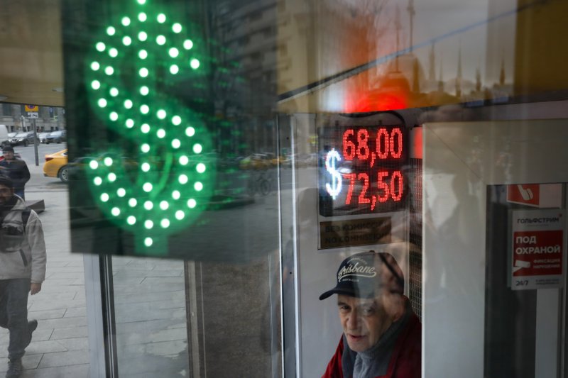 A man stands at an exchange office screen showing the currency exchange rates of U.S. Dollar and Euro to Russian Rubles in Moscow, Russia, on March 10. Oil prices are plunging after Saudi Arabia started a price war against Russia. The Saudis tried to get the Russians to cut oil production to keep prices from falling even more due to the coronavirus. - AP Photo/Pavel Golovkin