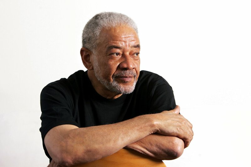 In this June 21, 2006 file photo, singer-songwriter Bill Withers poses in his office in Beverly Hills, Calif. Withers, who wrote and sang a string of soulful songs in the 1970s that have stood the test of time, including “Lean On Me,” “Lovely Day” and “Ain’t No Sunshine," died in Los Angeles from heart complications on Monday, March 30, 2020. He was 81. (AP Photo/Reed Saxon, File)