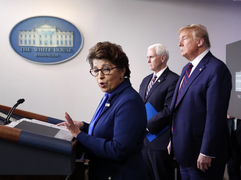 In this Thursday, April 2, 2020 file photo, Jovita Carranza, administrator of the Small Business Administration, speaks about the coronavirus in the James Brady Press Briefing Room of the White House n Washington, as Vice President Mike Pence, President Donald Trump listen.  (AP Photo/Alex Brandon, File)