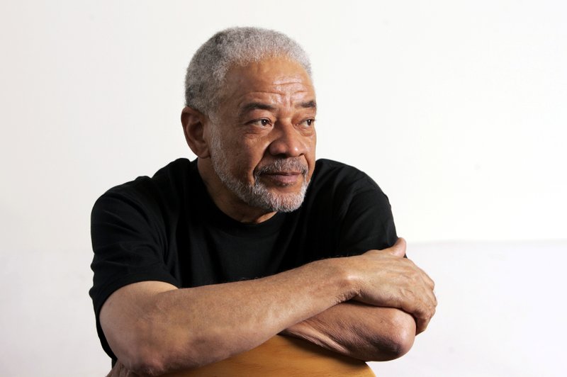 FILE - In this June 21, 2006 file photo, singer-songwriter Bill Withers poses in his office in Beverly Hills, Calif. Withers, who wrote and sang a string of soulful songs in the 1970s that have stood the test of time, including &#x201c;Lean On Me,&#x201d; &#x201c;Lovely Day&#x201d; and &#x201c;Ain&#x2019;t No Sunshine,&quot; died in Los Angeles from heart complications on Monday, March 30, 2020. He was 81. (AP Photo/Reed Saxon, File)