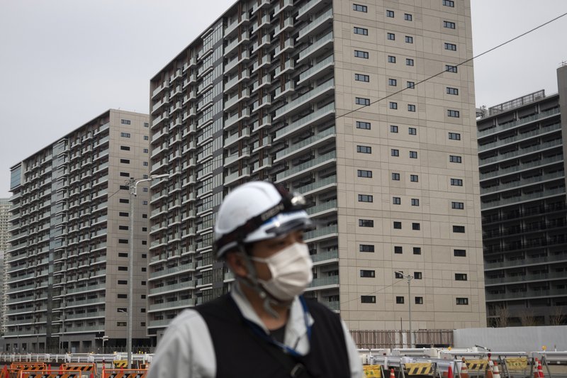 A worker walks through the athletes village March 23 for the Tokyo 2020 Olympics, in Tokyo. Tokyo's governor is considering the possibility of using the unfinished Olympic Athletes Village as a temporary hospital for coronavirus infected patients. The massive village on Tokyo Bay could house up to 18,000 people during the Olympics. - Photo by Jae C. Hong of The Associated Press