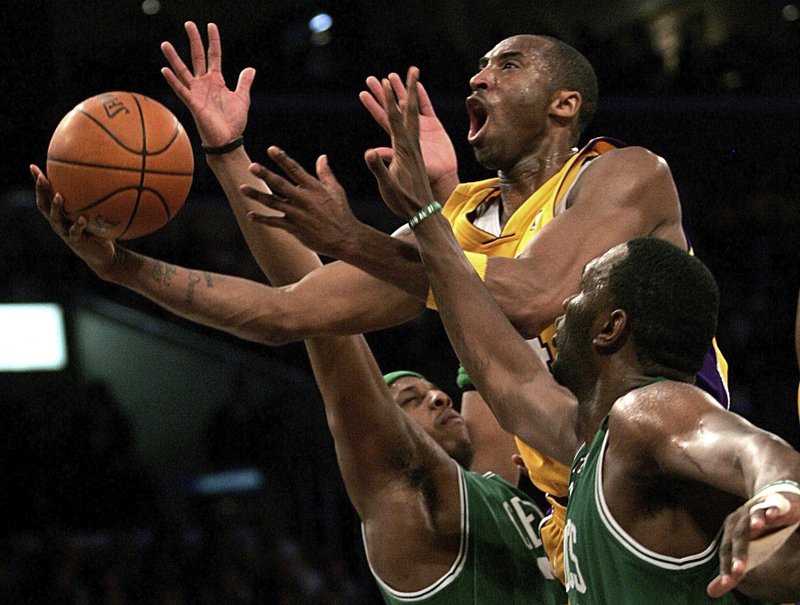 Los Angeles Lakers' Kobe Bryant, top, goes up for a shot between Boston Celtics' Paul Pierce, left, and Al Jefferson Feb. 23, 2017, during the first half of an NBA game in Los Angeles. Kobe Bryant, Tim Duncan and Kevin Garnett are all expected to be officially announced as members of the 2020 enshrinement class for the Basketball Hall of Fame today. - Photo by Branimir Kvartuc of The Associated Press