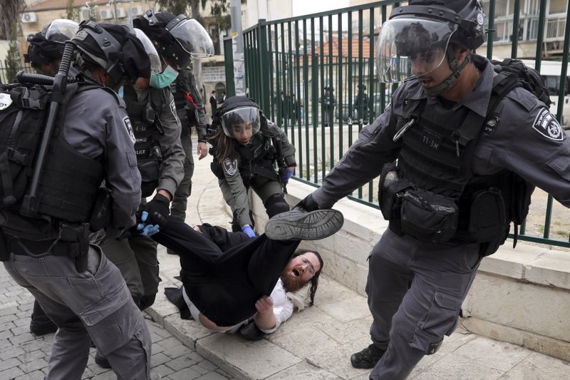 File - In this Monday, March 30, 2020 file photo, Israeli police arrest an Ultra Orthodox Jew during protest against government's measures to stop the spread of the coronavirus in the orthodox neighborhood of Mea Shearim in Jerusalem. (AP Photo/Mahmoud Illean, File)