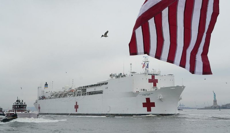 The arrival Monday of the U.S. Naval Ship Comfort in New York buoyed expectations of respite for the city’s overburdened hospitals. But the ship now sits basically empty, its 1,000 beds mostly unused and its 1,200-member crew with little to do. “If I’m blunt about it, it’s a joke,” said Michael Dowling, head of Northwell Health, New York’s largest hospital system. Comfort’s sister ship Mercy, docked at Los Angeles, also has been lightly used so far.
(The New York Times/Chang W. Lee)