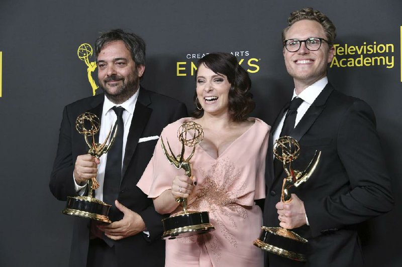 This Sept. 14, 2019 file photo shows Adam Schlesinger, from left, Rachel Bloom and Jack Dolgen in the press room with the awards for outstanding original music and lyrics for "Crazy Ex Girlfriend" at the Creative Arts Emmy Awards in Los Angeles. (Photo by Richard Shotwell/Invision/AP, File)