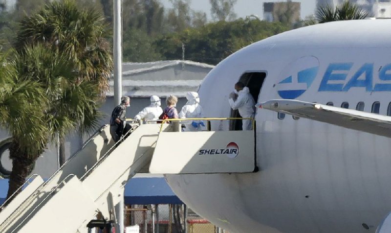Passengers from the cruise ship Rotterdam board a charter plane Friday at Fort Lauderdale/Hollywood International Airport in Fort Lauderdale, Fla. More photos at arkansasonline.com/44ships/.
(AP/Wilfredo Lee)