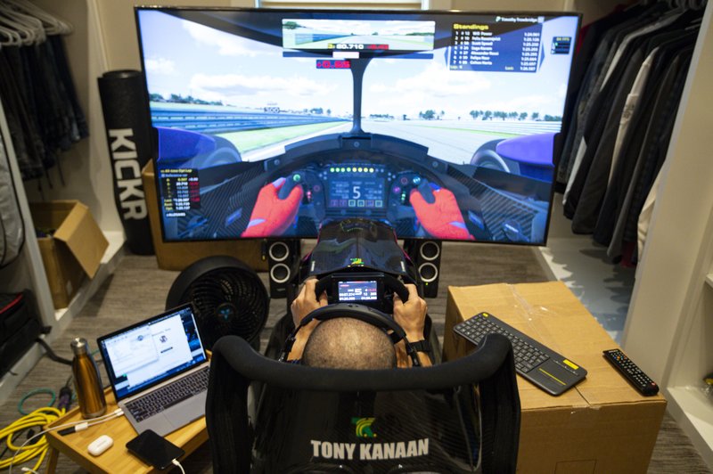IndyCar driver Tony Kanaan, of Brazil, uses a racing simulator in his home in Indianapolis on March 28 to practice for a virtual racing event. As Robert Wickens fought his way back from a spinal cord injury, he kept dreaming about the day he could run against his old racing buddies. The promising Canadian driver believes he'll take his biggest step yet by making his debut in the IndyCar iRacing Challenge -- a virtual race held Saturday on the Barber Motorsports Track in Alabama. - Photo by Michael Conroy of The Associated Press