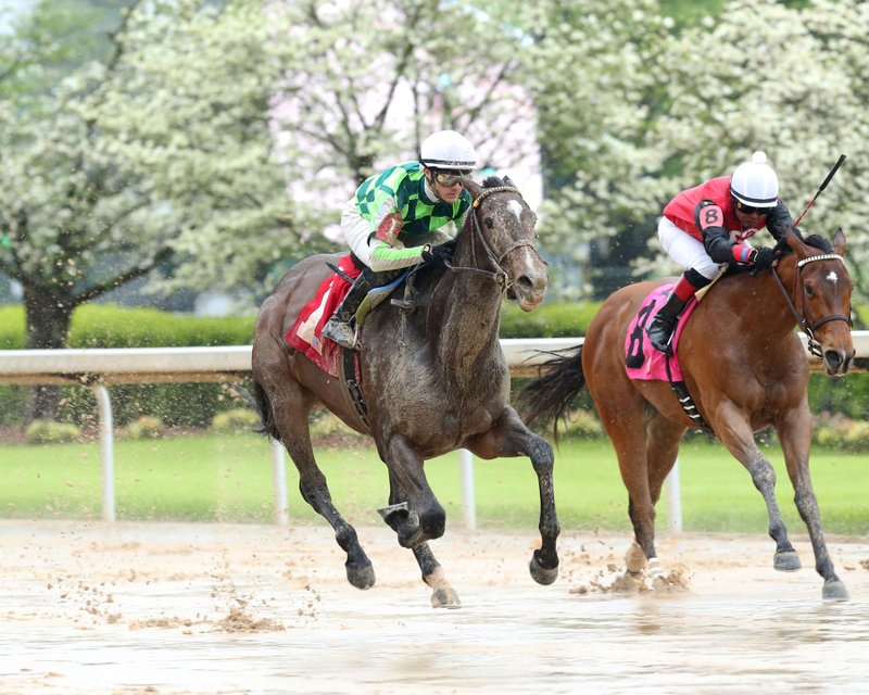 Jockey Channing Hill, left, guides Kimari (1) across the wire in front of Martin Garcia and Frank's Rockette (8) to win the $100,000 Purple Martin Stakes by 1 3/4 lengths at Oaklawn Park Saturday, April 4. - Photo courtesy of Coady Photography