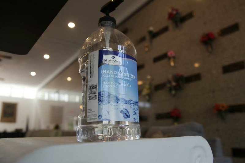 A large bottle of hand sanitizer is available for visitors inside the chapel at Woodridge Memorial Park & Funeral Home in Lexington, S.C., on Friday. A sign asked people to refrain from shaking hands because of the coronavirus outbreak.
(AP/Sarah Blake Morgan)