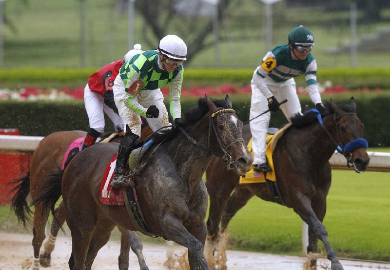 Channing Hill (left) rode Kimari to victory in the Purple Martin Stakes on Saturday at Oaklawn in Hot Springs. Kimari’s winning time in the 6-furlong race was 1:10.57. (Arkansas Democrat-Gazette/Thomas Metthe) 

