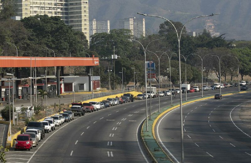 Motorists wait in line to refuel their vehicles Thursday in Caracas, Venezuela. More photos at arkansasonline.com/45venezuela/.
(AP/Ariana Cubillos)