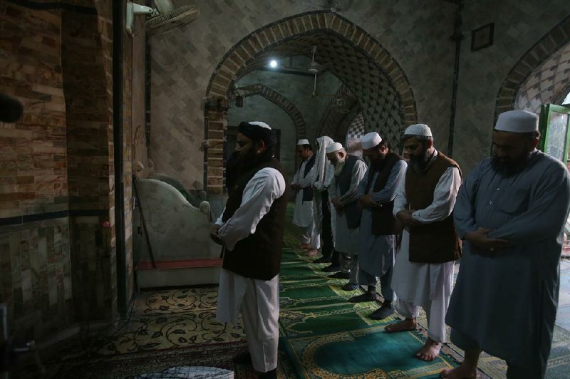 Worshippers pray at a mosque in Peshawar, Pakistan, on Friday despite government restrictions intended to slow the spread of the coronavirus.
(AP/Muhammad Sajjad)