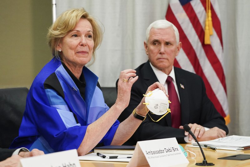 In this March 5 file photo, Dr. Deborah Birx, Ambassador and White House coronavirus response coordinator, holds a 3M N95 mask as Vice President Mike Pence visits 3M headquarters in Maplewood, Minn., in a meeting with 3M leaders and Minnesota Gov. Tim Walz to coordinate response to the COVID-19 virus. A review of federal purchasing contracts by The Associated Press shows federal agencies waited until mid-March to begin placing bulk orders of N95 respirator masks, mechanical ventilators and other equipment needed by front-line health care workers. - Glen Stubbe/Star Tribune via AP