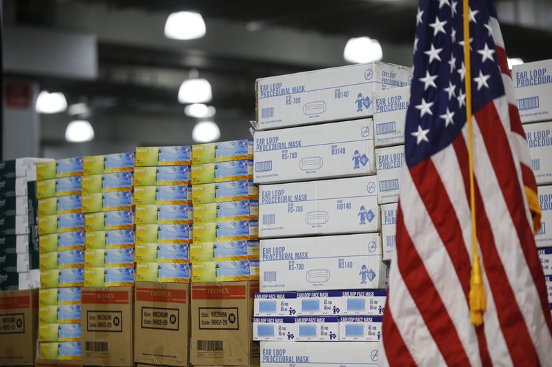 FILE - In this March 24 file photo stacks of medical supplies are housed at the Jacob Javits Center that will become a temporary hospital in response to the COVID-19 outbreak in New York. A review of federal purchasing contracts by The Associated Press shows federal agencies waited until mid-March to begin placing bulk orders of N95 respirator masks, mechanical ventilators and other equipment needed by front-line health care workers. - AP Photo/John Minchillo