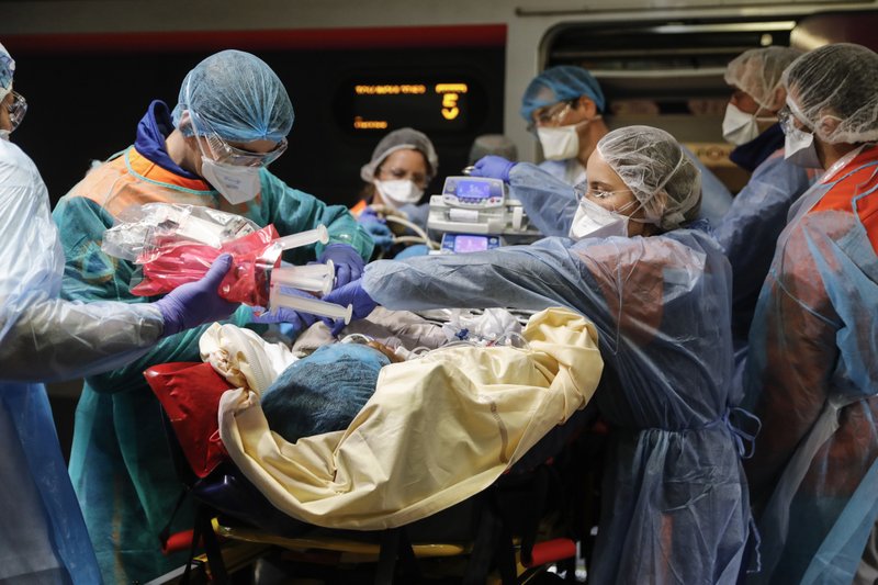 Medical staffs wait as patients from Paris and infected with the Covid-19 virus are expected in a hospital Sunday, in Rennes, western France. France is moving hundreds of critically ill COVID-19 patients around the country on specially tted high-speed trains. More photos at arkansasonline. com/46france/ (AP/David Vincent) 
