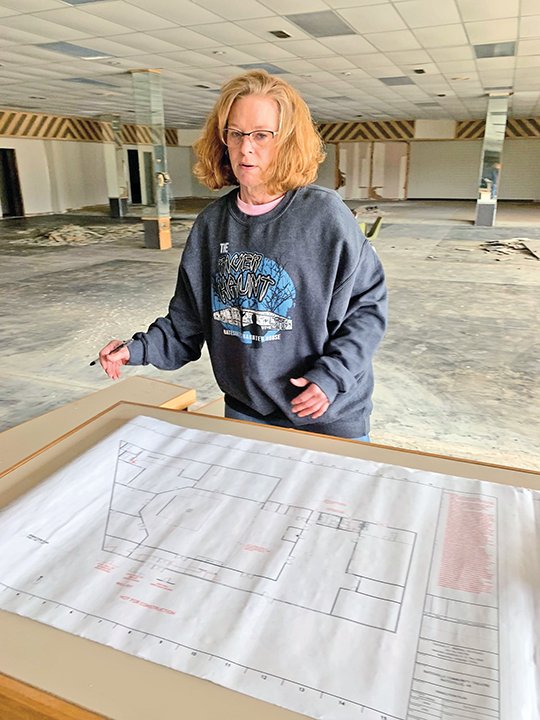 Suzanne Magouyrk looks at the remodeling plans for the new home of the Batesville Community Theatre in the Town Plaza Shopping Center on Main Street. 