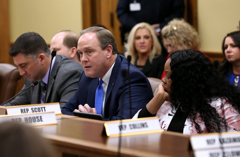 FILE - Rep. Les Warren (center), R-Hot Springs, speaks against a bill as Rep. Jamie Scott, D-North Little Rock, looks on during the House Committee on State Agencies and Governmental Affairs meeting on Wednesday, March 20, 2019.
