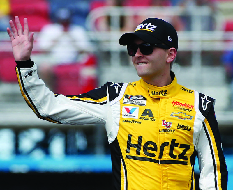 William Byron waves to fans during driver introductions prior to the NASCAR Cup Series auto race at Phoenix Raceway, Sunday, March 8, 2020, in Avondale, Ariz. (AP Photo/Ralph Freso)
