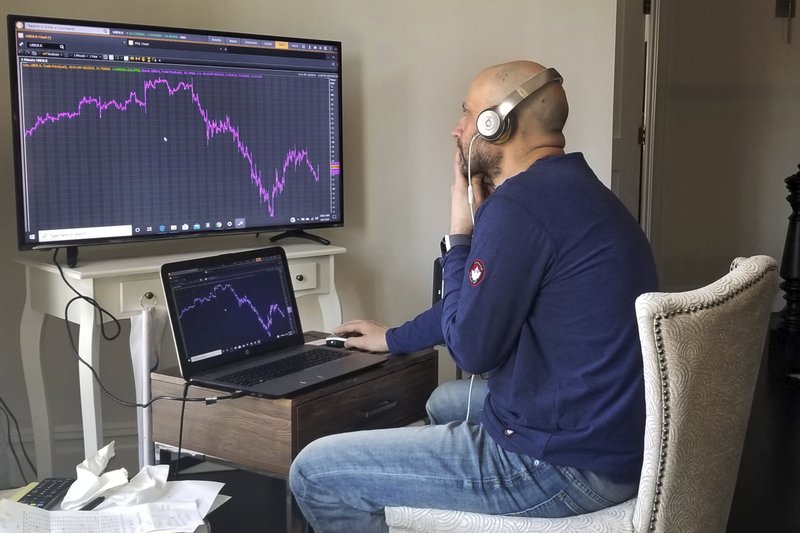 Meric Greenbaum, who normally works on the New York Stock Exchange’s trading floor, is shown in his home office Monday in Shelter Island, N.Y. Video available at arkansasonline.com/47rise/. (AP/Lucas Greenbaum) 

