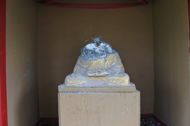 A religious statue stands destroyed at Wat Lao Santitham, a Buddhist temple in Fort Smith, Tuesday, April 7, 2020. (Arkansas Democrat-Gazette/Thomas Saccente)