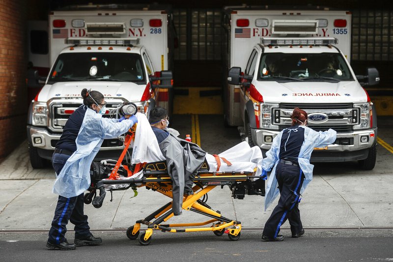 Patients are brought into Wyckoff Heights Medical Center by staff wearing personal protective gear due to COVID-19 concerns, Tuesday, April 7, 2020, in the Brooklyn borough of New York.