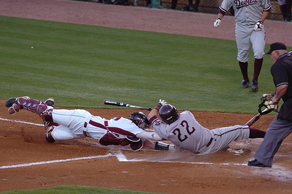 Arkansas catcher James McCann tags Arizona State base runner Jared McDonald (22) at the plate for an out in the second inning of a game Wednesday, April 8, 2009, in Fayetteville.