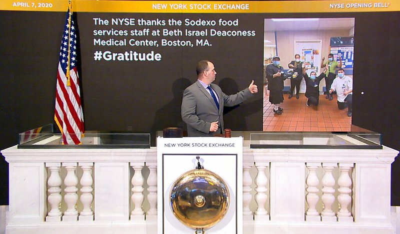 In this image taken from video provided by the New York Stock Exchange, Tommy Gannon, Assistant Supervisor, Facilities, rings the opening bell at the NYSE, and recognizes the Sodexo food services staff at Beth Israel Deaconess Medical Center in Boston, Tuesday, April 7, 2020, in New York.