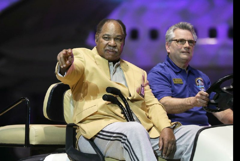 FILE - In this May 2, 2014, file photo, Bobby Mitchell is introduced before the inaugural Pro Football Hall of Fame Fan Fest at the International Exposition Center in Cleveland. Mitchell, the speedy late 1950s and 60s NFL offensive star for the Cleveland Browns and Washington Redskins, has died. He was 84. The Pro Football Hall of Fame said Sunday night, April 5, 2020, that Mitchell's family said he died in the afternoon. (AP Photo/Mark Duncan, File)