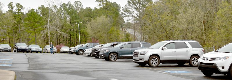 Keith Bryant/The Weekly Vista Churchgoers lined up, spaced for safety, at the Bella Vista Baptist Church parking lot for Sunday service broadcast on the radio.