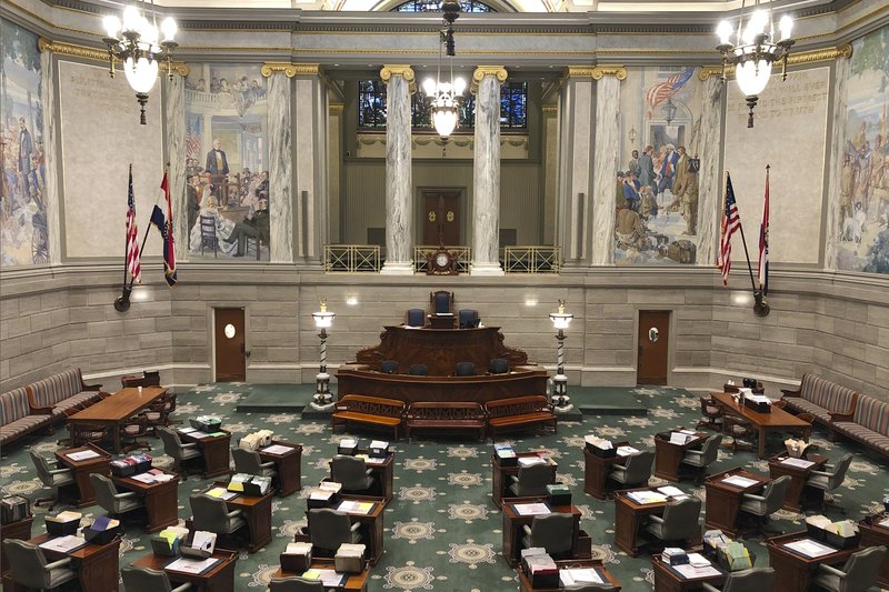 The Missouri Senate chamber sits empty on Thursday, March 12, 2020, in Jefferson City, Missouri, after senators adjourned for the day and announced they would not reconvene in a full session until at least March 30 because of concerns over the new coronavirus. Officials in state capitols across the country have been announcing new precautions intended to guard against the spread of the disease. For most people, the new coronavirus causes only mild or moderate symptoms, such as fever and cough. For some, especially older adults and people with existing health problems, it can cause more severe illness, including pneumonia. (Photo by David A. Lieb)