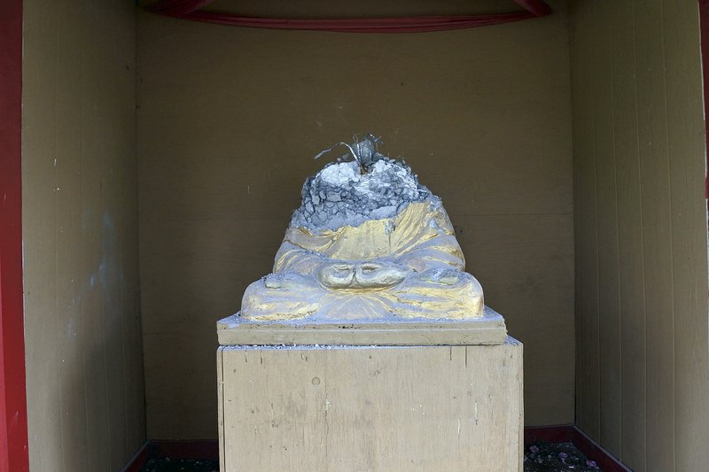 This statue at Wat Lao Santitham, a Buddhist temple in Fort Smith, sustained heavy damage in an attack April 5. Two other statues also were damaged. (Arkansas Democrat-Gazette/Thomas Saccente) 