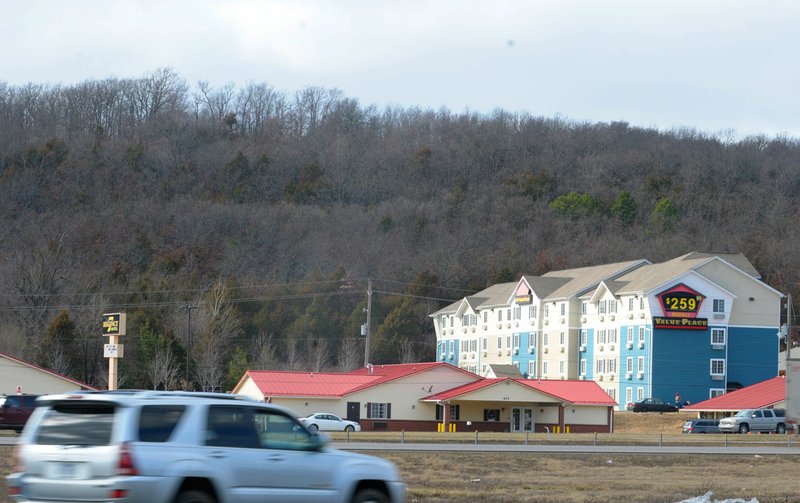 Millsap Mountain is seen looking west over commercial properties on Shiloh Drive and north of Martin Luther King Jr. Boulevard on Feb. 15, 2018, in Fayetteville. The City Council approved projects Tuesday to get going on the first phase of the Centennial Park buildout. (File photo/NWA Democrat-Gazette/David Gottschalk)