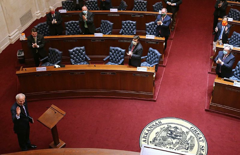 Gov. Asa Hutchinson gets a standing ovation Wednesday after his address in the Senate chamber at the state Capitol. Members of the House, who met at the Jack Stephens Center, watched via live video stream. More photos at arkansasonline.com/49gov/.
(Arkansas Democrat-Gazette/Thomas Metthe)