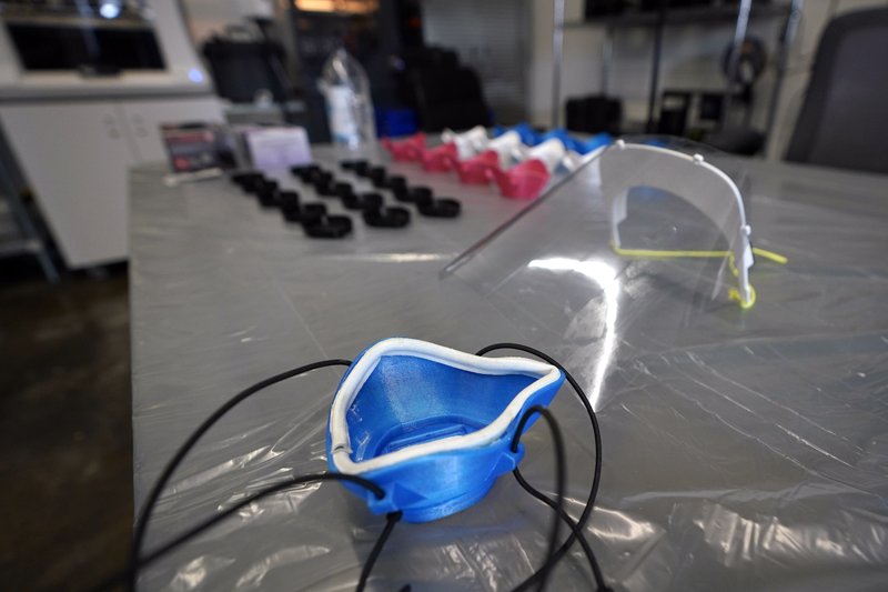 FILE – In this Friday, April 3, 2020 photo, a printed face mask and face shield are displayed at 3D-Standard LLC in Houston. (AP Photo/David J. Phillip)


