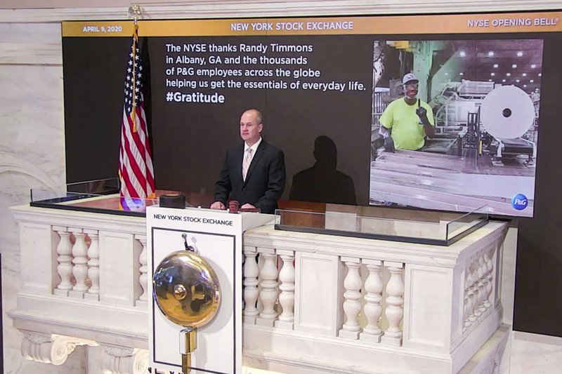 In this photo taken from video provided by the New York Stock Exchange, Chief Security Officer Kevin Fitzgibbons rings the opening bell at the NYSE, while recognizing Randy Timmons in Albany, Ga., and thousands of employees of the Proctor & Gamble Company, Thursday, April 9, 2020. (New York Stock Exchange via AP)

