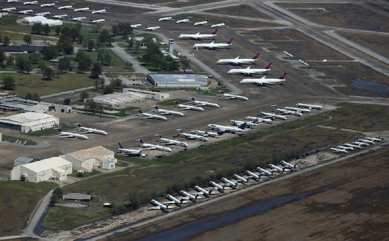 Delta Airlines jets sit on the tarmac Thursday at Arkansas International Airport in Blytheville. Aviation Repair Technologies, based at the airport, has accepted 77 aircraft since March 17. All have been idled because of a global slowdown in commercial air traffic related to the pandemic.
(Arkansas Democrat-Gazette/Thomas Metthe)