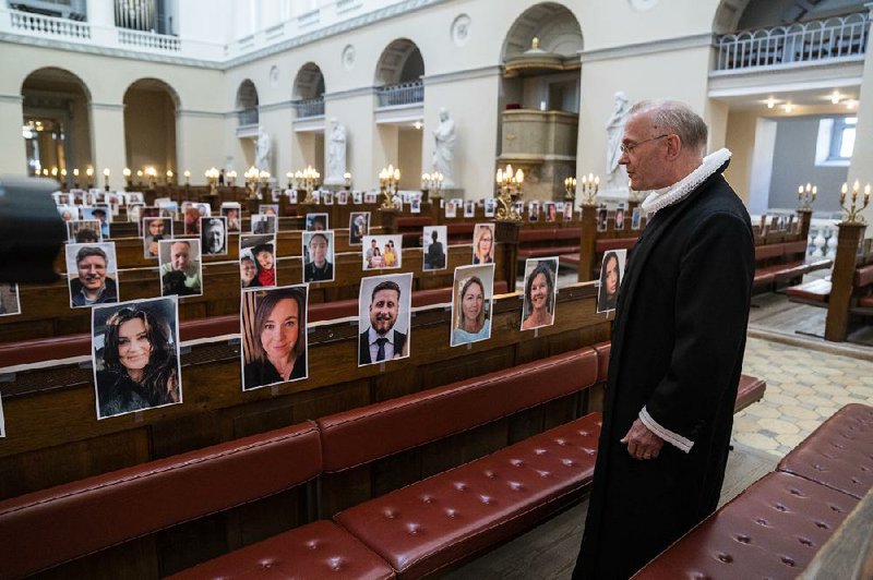 Anders Gadegaard, dean at Vor Frue Kirke ( Church of Our Lady) in Copenhagen, looks over the selfies his congregation sent in for a Good Thursday livestreaming worship service after the benediction. As Easter approaches, many religious denominations are holding virtual services, while others are planning rituals at drive-in theaters so people can worship in their cars.
(AP/Ritzau/Martin Sylvest)